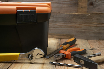 Tool box, hammer, pliers, on wooden background