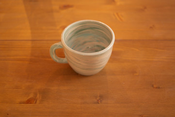 cup created with nerikomi technique on wooden table