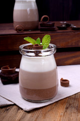 Three chocolate mousse dessert in a glass jar with mint