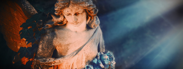 Ancient statue of beautiful angel in the sunlight