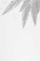 Christmas or winter composition. white snowflakes, silver tree branches on white background.