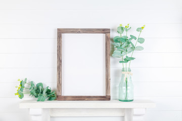 Spring or summer wooden frame mockup with greenery