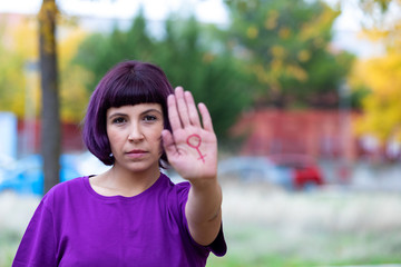 Woman with the female symbol drawn oh her hand