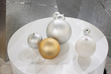 beautiful silver and gold christmas balls on a silver background