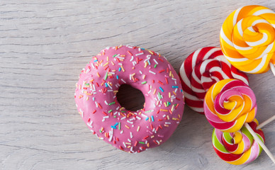 Colorful sweets. Lollipops and donuts. Top view with space for your text