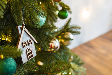 christmas toy wood house on fir branch , new year scandinavian decoration