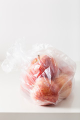 single use plastic packaging issue. apples in plastic bag