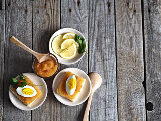 sandwiches of pike fish caviar with egg on a wooden wooden table