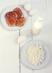 milk, eggs and cookies on the table