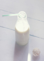 bottle and glass of milk with white background