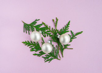 Christmas New year flat lay with pine tree, silver ball and branch on pink background. Greeting card, top view. 