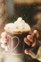 cup of coffee with whipped cream on wooden background