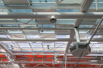 Ventilation system on the polycarbonate transparent ceiling in a wide hall.  