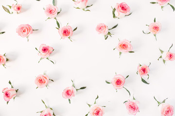 Flat lay frame border with blank copy space mockup made of pink rose flower buds on white background. Top view floral concept.