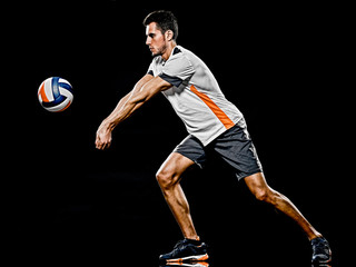 one caucasian young volley ball player man in studio isolated on black background © snaptitude