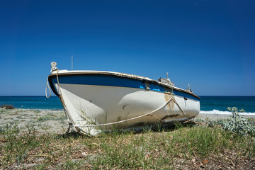 A boat to the beach on the Aegean coast in Greece.