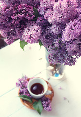 cup of coffee and flowers on table