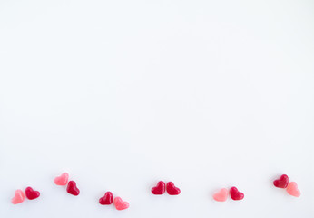 Valentines day card with tiny candy sweet hearts on white background. Flat lay, top view, copy space. 