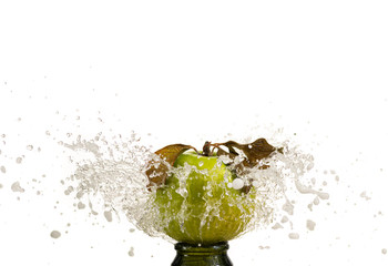 An apple hanging in a stream of water fountain