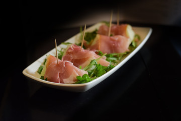 Italian antipasti mellon in parma ham served on elegant plate