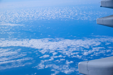 blue sky and cloudy view from window airplane fly high for transportation.