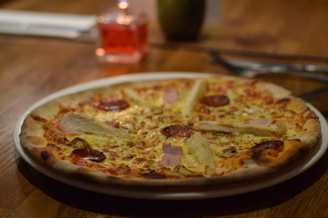 Chicken and peperoni pizza in the italian resaurant table