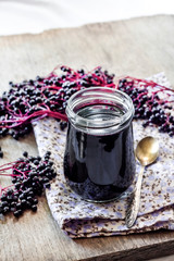 Obraz na płótnie Canvas Homemade black elderberry syrup in glass jar