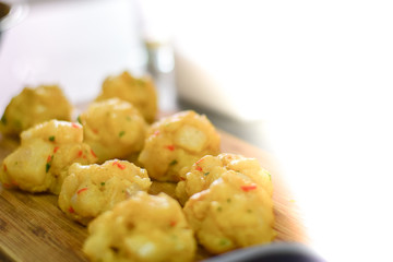 Raw fish meat balls on the board
