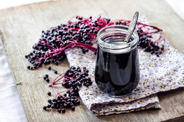 Homemade black elderberry syrup in glass jar