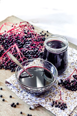 Fototapeta na wymiar Homemade black elderberry syrup in glass jar