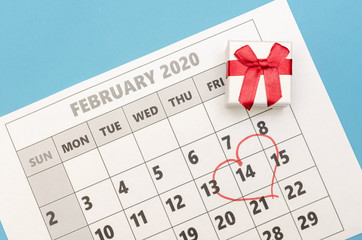 Valentine's day is marked with a heart on the calendar, there is a box with a ring next to it. Concept of Valentine's day, holiday