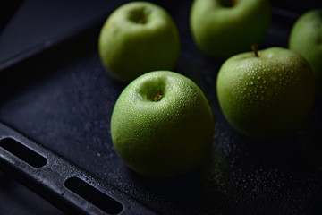 green apples on black background