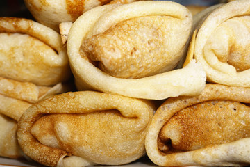 Hearty and tasty breakfast or lunch. Thin fried pancakes with lamb meat close-up. Maslenitsa.