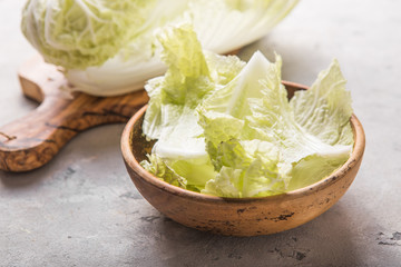 Peking fresh chinese cabbages in wood bowl on a white background. top view. Vegetarian, slimming, diet food concept. Flat lay