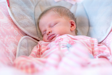 Young Baby Sleeping Peacefully at Home in Bouncer