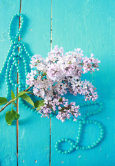 flower and blue pearls on the table