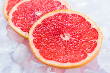 Fototapeta na wymiar Grapefruit slices on ice. Close-up.