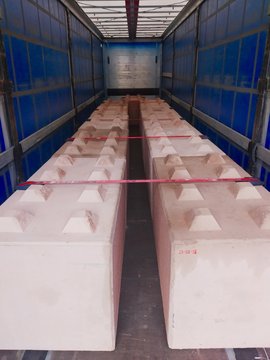 Reinforced concrete cubes to protect, for example, Christmas markets from car attacks. Blocks are loaded in the truck trailer.Concrete protective blocks and courts in the cargo compartment of the truc