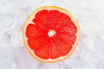 One slice of grapefruit on ice. Close-up.