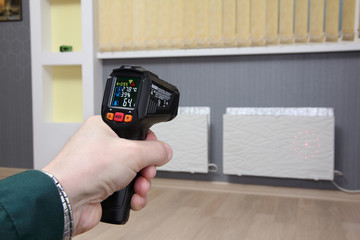 Infrared thermometer in hand