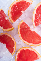 Slices of grapefruit on ice. Close-up.
