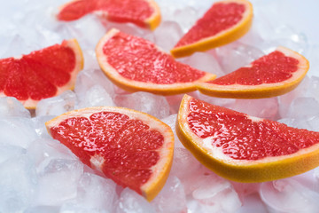 Slices of grapefruit on ice. Close-up.