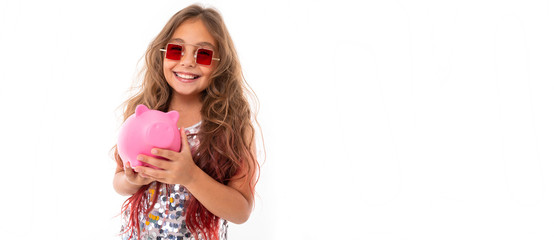 Little pretty caucasian girl with pink pig mobeybox, panorama isolated on white background