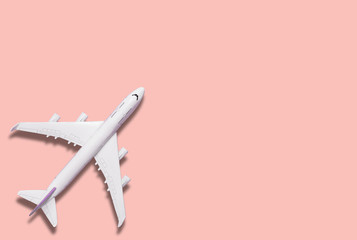 Airplane model and text space on pink background