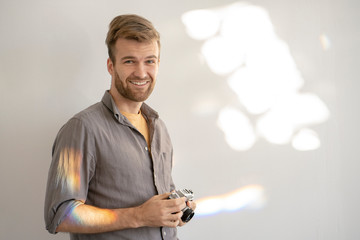 Portrait of smiling man holding old-fashioned camera