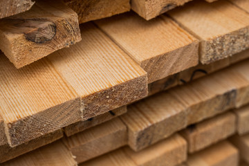 Piles of wooden boards in the sawmill, planking. Warehouse for sawing boards on a sawmill outdoors....