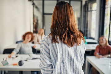 Rear view of businesswoman leading a workshop in conference room