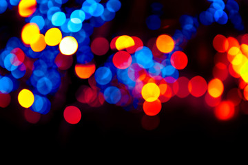 Colorful circles bokeh festive glitter dark background. Holiday greeting cards, invitations, flyers, blog posts, banners design. Christmas lights bokeh overlay.