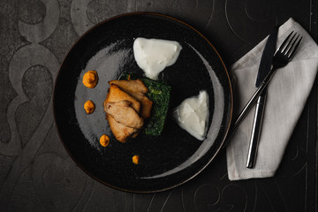 Grilled chicken breast with boiled spinach an hot cheese. top view served for restaurant