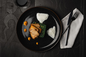 Grilled chicken breast with boiled spinach an hot cheese. top view served for restaurant